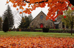 Exterior of St. Joseph Abbey church in fall