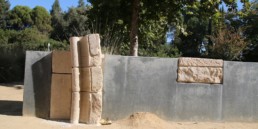 blocks of ancient stone inlayed into concrete wall