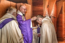 Preparing for Lent: Priest imposes ashes on forehead of monk