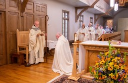 Br. Mary John Blaschik kneels in front of Abbot Joseph at Holy Cross Abbey