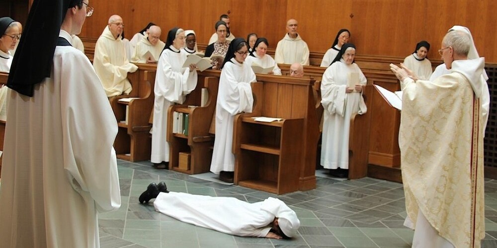 Sister Ashwini prostrate for Solemn Profession as priest blesses her
