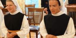 Sister Annie and Sister Mary kneel as they make their first profession of vows at OLM