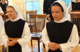 Sister Annie and Sister Mary kneel as they make their first profession of vows at OLM