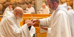 Elderly monk receiving Holy Communion from a Priest-Monk