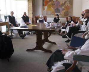 Novice Director's meeting, sitting in chairs around a table