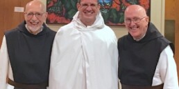 Fr. Stephen in novice habit, flanked by Fr. Joe and Fr. Kevin.