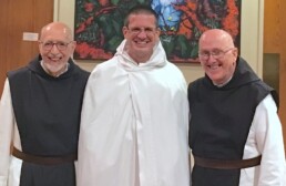 Fr. Stephen in novice habit, flanked by Fr. Joe and Fr. Kevin.