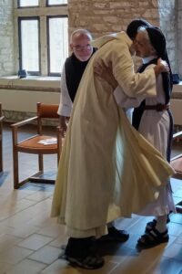 Br. Phillip receives a hug from Sr. Kathleen as he becomes a novice monk at New Melleray Abbey