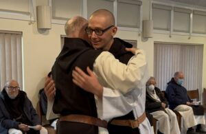 Fr. Paul Mark hugs Br. Isaac in congratulation of first vows