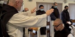 Fr. Paul Mark of New Clairvaux with hands outstretched over Brother Isaac